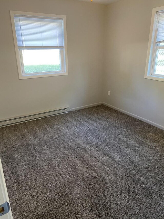 275 E Prairie St, Manhattan, IL 60442 - empty room with baseboard heating, carpet floors, and baseboards