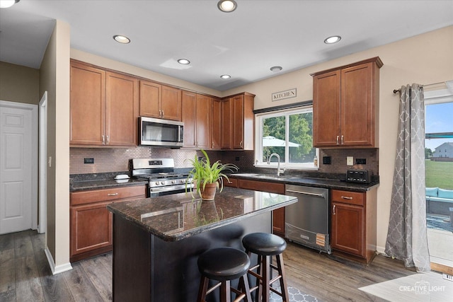 1104 Breckenridge Ln, Shorewood, IL 60404 - kitchen featuring stainless steel appliances, dark wood-style floors, dark stone counters, brown cabinetry, and recessed lighting