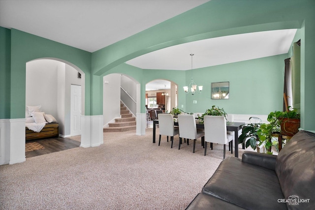 1104 Breckenridge Ln, Shorewood, IL 60404 - dining room with arched walkways, carpet flooring, a chandelier, stairs, and a wainscoted wall