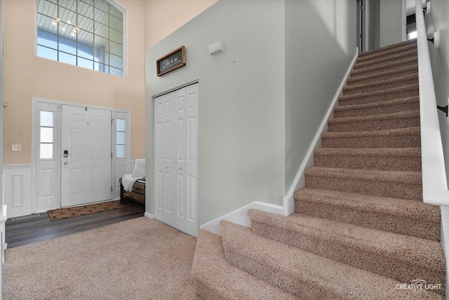 1104 Breckenridge Ln, Shorewood, IL 60404 - carpeted entryway featuring stairs, a towering ceiling, and wood finished floors