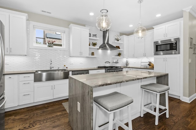 439 Thomas Ave, Forest Park, IL 60130 - kitchen with appliances with stainless steel finishes, wall chimney range hood, open shelves, white cabinetry, and recessed lighting