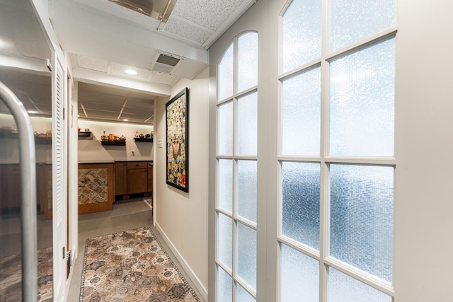 10 N Broadview Ave, Lombard, IL 60148 - hall featuring baseboards, a drop ceiling, and stone finish floors
