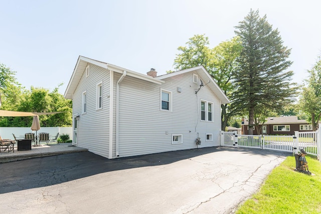 10 N Broadview Ave, Lombard, IL 60148 - rear view of house featuring a gate, a chimney, and a patio area