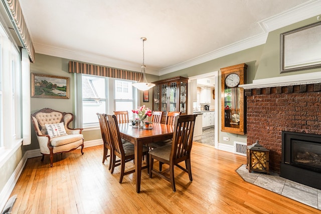 10 N Broadview Ave, Lombard, IL 60148 - dining room with baseboards, light wood-style floors, ornamental molding, and a fireplace