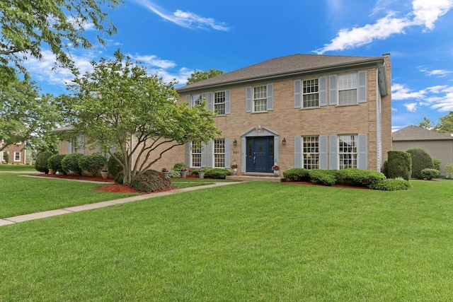 801 Fieldale Ln, Grayslake, IL 60030 - colonial inspired home with a front lawn and brick siding