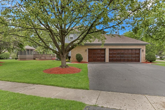 801 Fieldale Ln, Grayslake, IL 60030 - view of front of house featuring asphalt driveway, an attached garage, a front lawn, and roof with shingles