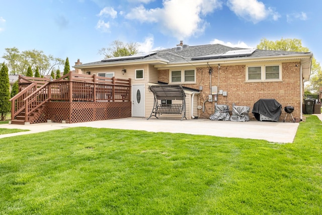 9330 Kolmar Ave, Skokie, IL 60076 - back of property featuring a patio, a deck, and a lawn