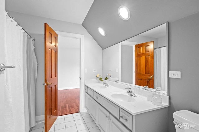 800 Diamond Head Dr E, Shorewood, IL 60404 - bathroom with double vanity, toilet, lofted ceiling, tile patterned flooring, and baseboards