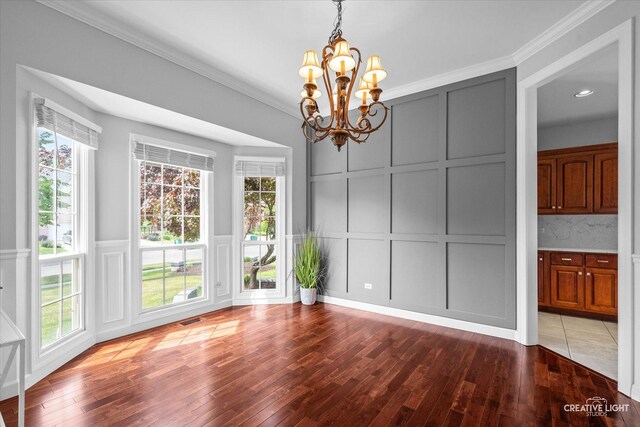 800 Diamond Head Dr E, Shorewood, IL 60404 - unfurnished dining area featuring a decorative wall, a chandelier, hardwood / wood-style flooring, plenty of natural light, and crown molding