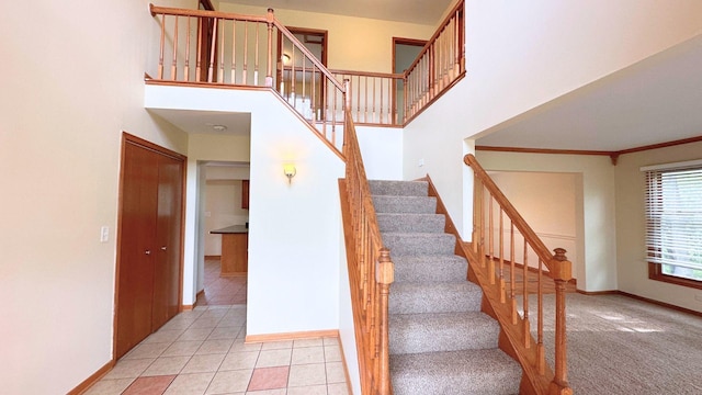 3420 203rd St, Olympia Fields, IL 60461 - staircase with baseboards, a towering ceiling, tile patterned flooring, and crown molding