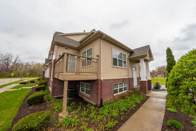 2433 River Oaks Ln Unit 6, Rockford, IL 61102 - view of home's exterior with a lawn and brick siding