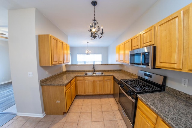 2433 River Oaks Ln Unit 6, Rockford, IL 61102 - kitchen featuring stainless steel appliances, a sink, a chandelier, light tile patterned floors, and hanging light fixtures