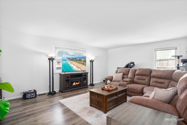 125 S Pinecrest Rd, Bolingbrook, IL 60440 - living area featuring healthy amount of natural light, wood finished floors, and a warm lit fireplace