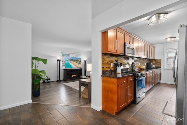 125 S Pinecrest Rd, Bolingbrook, IL 60440 - kitchen with appliances with stainless steel finishes, plenty of natural light, backsplash, and brown cabinetry