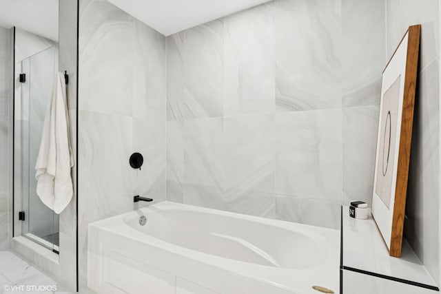 130 N Garland Ct Unit 2009, Chicago, IL 60602 - bathroom with a bath, a stall shower, and marble look tile flooring