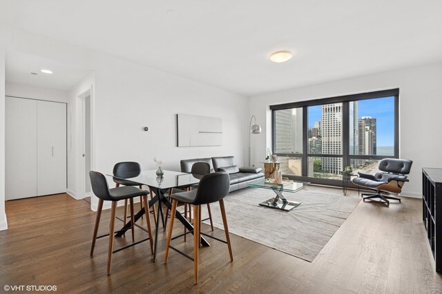 130 N Garland Ct Unit 2009, Chicago, IL 60602 - dining space with wood finished floors, baseboards, and a view of city