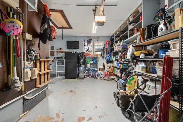 1211 Schriber Ave, Joliet, IL 60435 - garage featuring freestanding refrigerator and a garage door opener