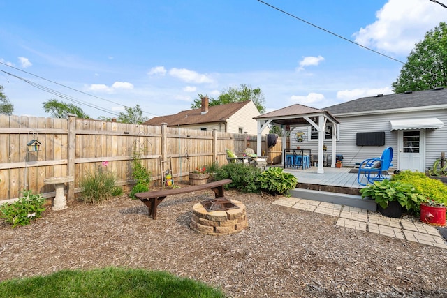 1211 Schriber Ave, Joliet, IL 60435 - fenced backyard with an outdoor fire pit, a gazebo, and a deck