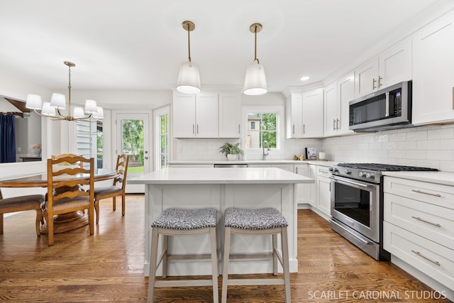 112 Danada Dr, Wheaton, IL 60189 - kitchen featuring stainless steel appliances, a chandelier, backsplash, light countertops, and recessed lighting