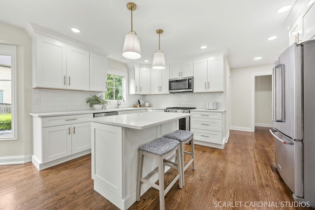 112 Danada Dr, Wheaton, IL 60189 - kitchen featuring appliances with stainless steel finishes, white cabinets, light countertops, backsplash, and recessed lighting