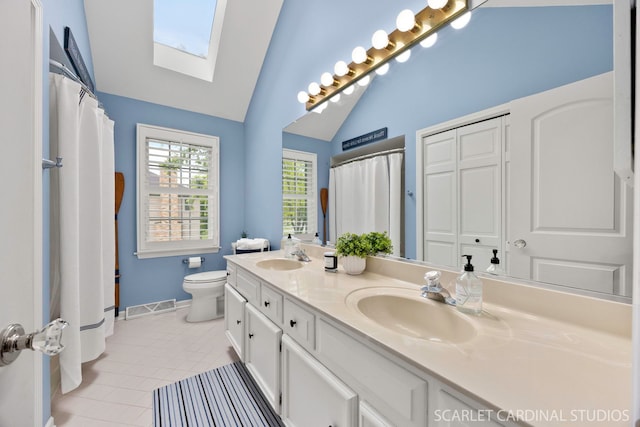 112 Danada Dr, Wheaton, IL 60189 - bathroom with double vanity, a skylight, vaulted ceiling, toilet, and tile patterned floors
