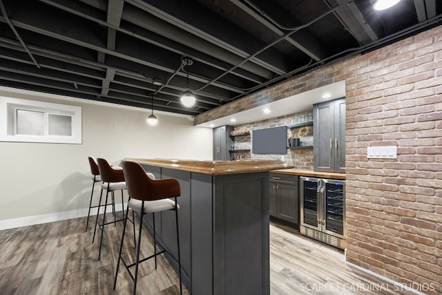 112 Danada Dr, Wheaton, IL 60189 - indoor wet bar with beverage cooler, light wood-style flooring, baseboards, and brick wall