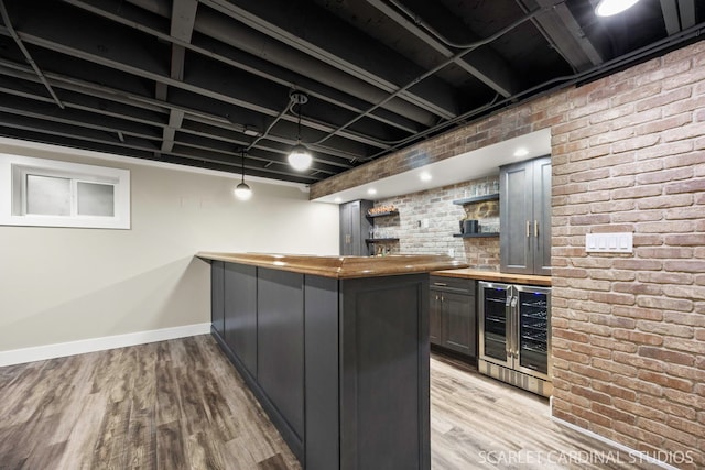 112 Danada Dr, Wheaton, IL 60189 - indoor wet bar featuring wine cooler, light wood-type flooring, brick wall, and baseboards
