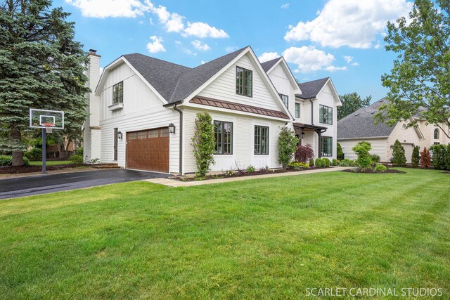 112 Danada Dr, Wheaton, IL 60189 - view of front of house with a standing seam roof, a chimney, driveway, an attached garage, and a front lawn
