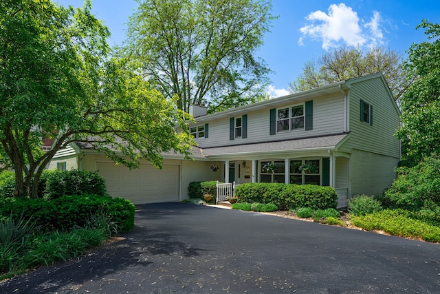 846 Park Dr, Flossmoor, IL 60422 - traditional-style home with covered porch, asphalt driveway, a garage, and a chimney