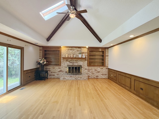 1463 Lantern Cir, Naperville, IL 60540 - unfurnished living room featuring a wainscoted wall, a decorative wall, built in features, light wood finished floors, and ceiling fan
