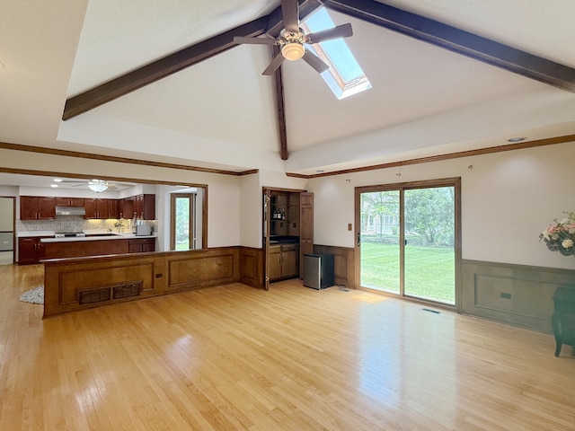 1463 Lantern Cir, Naperville, IL 60540 - unfurnished living room featuring a ceiling fan, beam ceiling, a wainscoted wall, light wood-style flooring, and a skylight