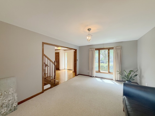 1463 Lantern Cir, Naperville, IL 60540 - unfurnished room featuring carpet, stairs, baseboards, and a chandelier