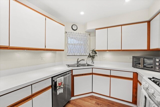 1051 Rockport Dr, Carol Stream, IL 60188 - kitchen with stainless steel dishwasher, a sink, light countertops, white cabinetry, and white range with gas stovetop