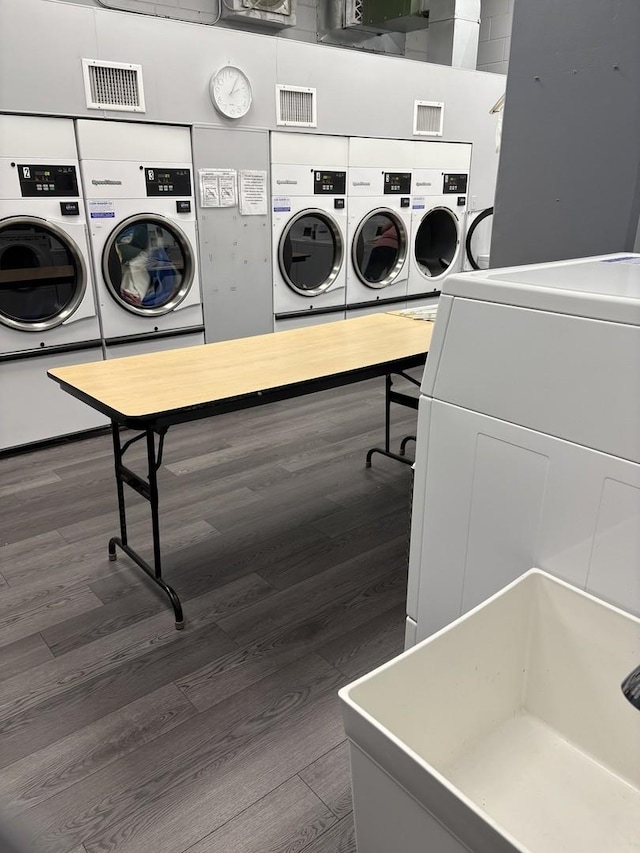 40 N Tower Rd Unit 5B, Oak Brook, IL 60523 - shared laundry featuring washer and clothes dryer, dark wood-style flooring, and estacked washer and dryer