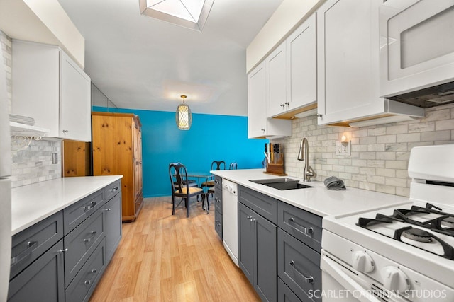 40 N Tower Rd Unit 5B, Oak Brook, IL 60523 - kitchen with white appliances, a sink, white cabinets, light wood-style floors, and light countertops