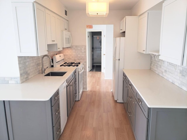 40 N Tower Rd Unit 5B, Oak Brook, IL 60523 - kitchen with white appliances, light wood-style flooring, gray cabinets, and backsplash