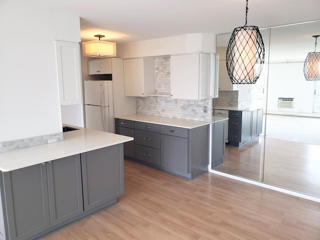 40 N Tower Rd Unit 5B, Oak Brook, IL 60523 - kitchen featuring freestanding refrigerator, gray cabinetry, light wood-style floors, and backsplash