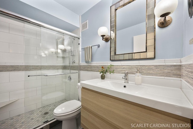 40 N Tower Rd Unit 5B, Oak Brook, IL 60523 - bathroom with vanity, a stall shower, toilet, tile walls, and wainscoting