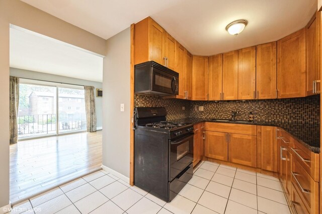 1315 N Baldwin Ct Unit 2C, Palatine, IL 60074 - kitchen featuring black appliances, a sink, backsplash, and brown cabinetry