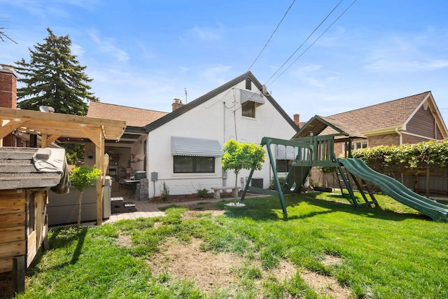 1844 N 77th Ct, Elmwood Park, IL 60707 - rear view of property with a playground, a lawn, and a chimney