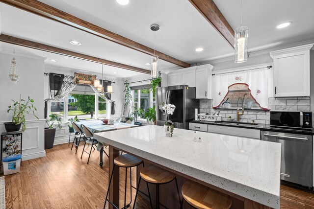1844 N 77th Ct, Elmwood Park, IL 60707 - kitchen with a sink, stainless steel appliances, beam ceiling, decorative backsplash, and white cabinetry