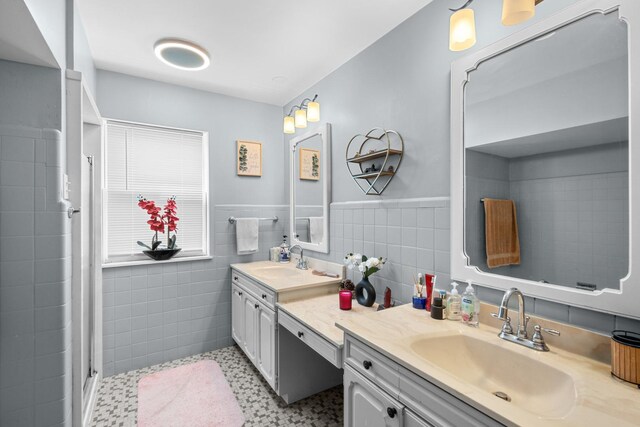 1844 N 77th Ct, Elmwood Park, IL 60707 - bathroom featuring tile walls, double vanity, a stall shower, and a wainscoted wall