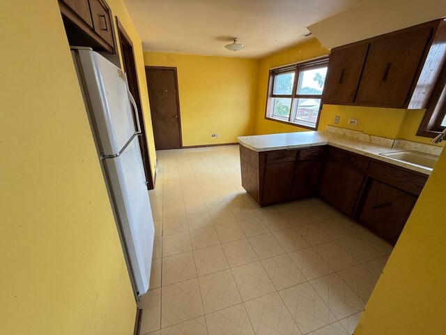 1235 S Mannheim Rd, Westchester, IL 60154 - kitchen with a sink, light countertops, a peninsula, and dark brown cabinets