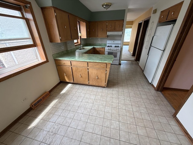 1235 S Mannheim Rd, Westchester, IL 60154 - kitchen featuring white appliances, under cabinet range hood, a sink, and plenty of natural light