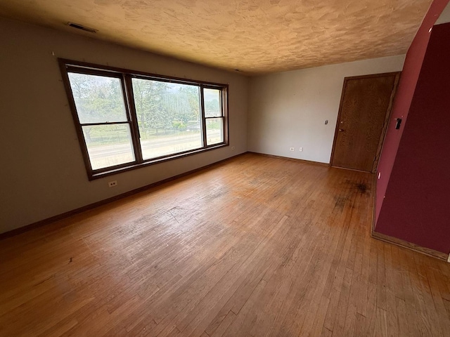 1235 S Mannheim Rd, Westchester, IL 60154 - unfurnished room featuring baseboards, light wood-style floors, and a textured ceiling