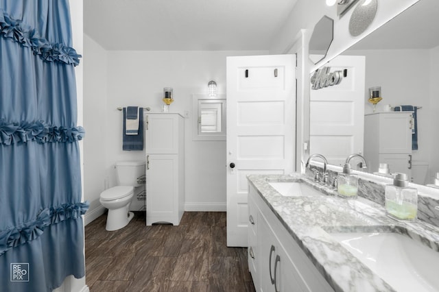 712 Lebanon St, Aurora, IL 60505 - bathroom featuring double vanity, toilet, and baseboards