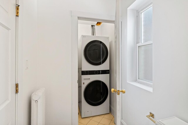 847 S Humphrey Ave Unit 3, Oak Park, IL 60304 - laundry area with stacked washer / dryer, light tile patterned floors, and radiator