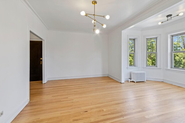 847 S Humphrey Ave Unit 3, Oak Park, IL 60304 - unfurnished room with radiator, ornamental molding, light wood-style flooring, a chandelier, and baseboards