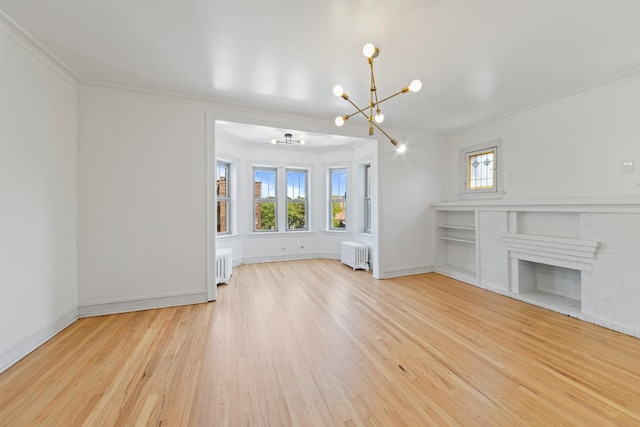 847 S Humphrey Ave Unit 3, Oak Park, IL 60304 - unfurnished living room with a chandelier, radiator, crown molding, wood finished floors, and a brick fireplace