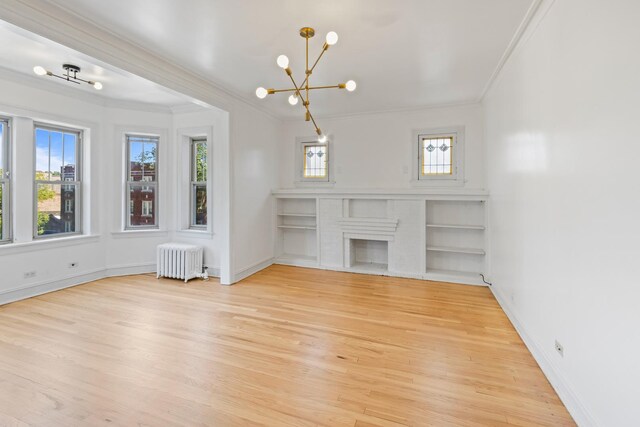 847 S Humphrey Ave Unit 3, Oak Park, IL 60304 - unfurnished living room featuring radiator heating unit, crown molding, a chandelier, light wood finished floors, and baseboards